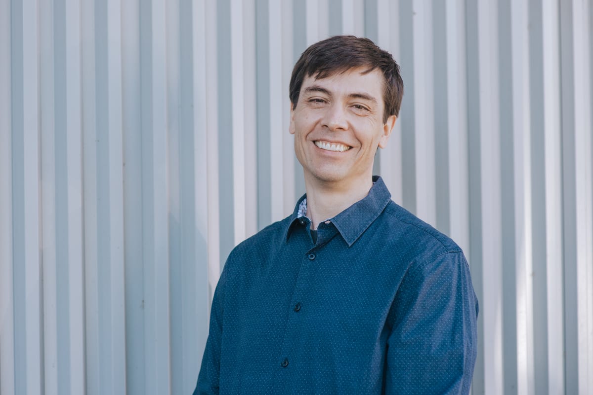 Chris Pettingill in front of a corrugated metal wall